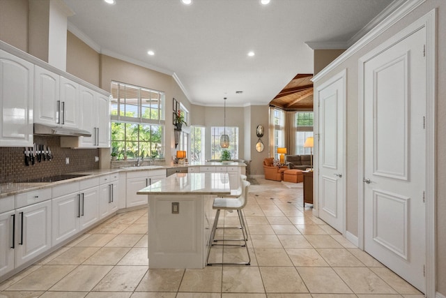 kitchen featuring white cabinetry, a kitchen island, decorative light fixtures, decorative backsplash, and light tile patterned floors