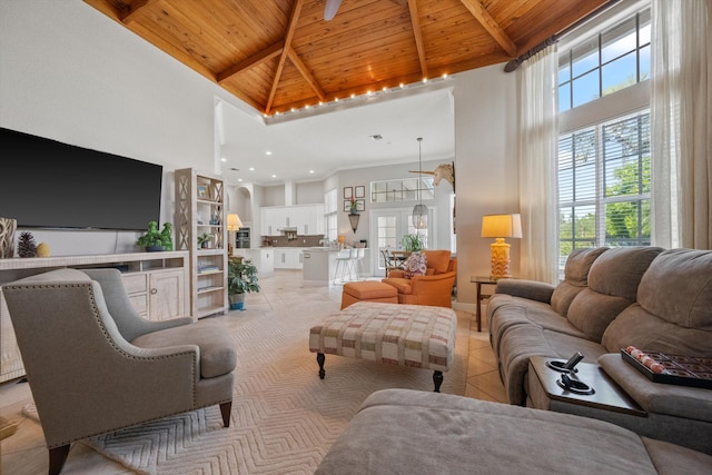 tiled living room with a high ceiling, wooden ceiling, and beam ceiling