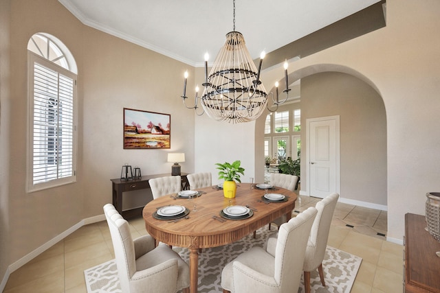 tiled dining space with an inviting chandelier and crown molding