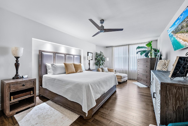 bedroom with dark hardwood / wood-style flooring and ceiling fan