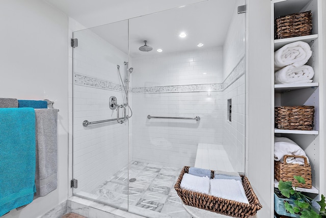 bathroom with a shower with door