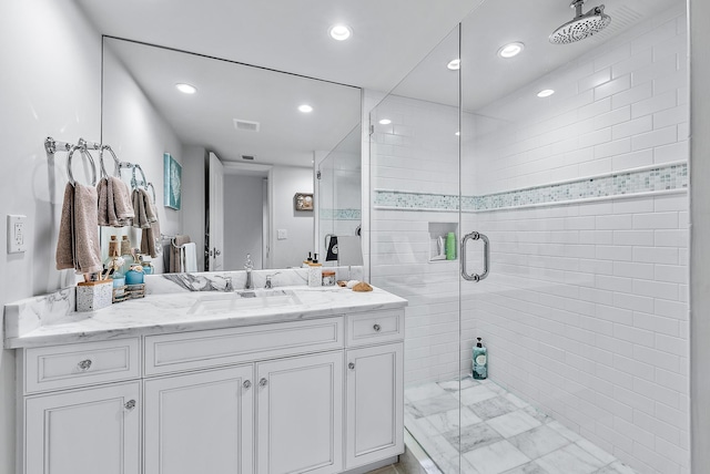 bathroom featuring vanity and a shower with shower door