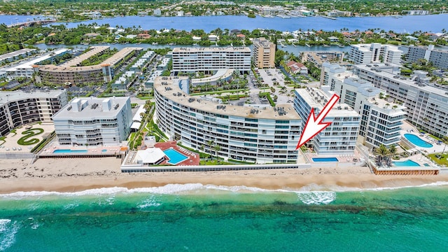 birds eye view of property with a water view and a view of the beach