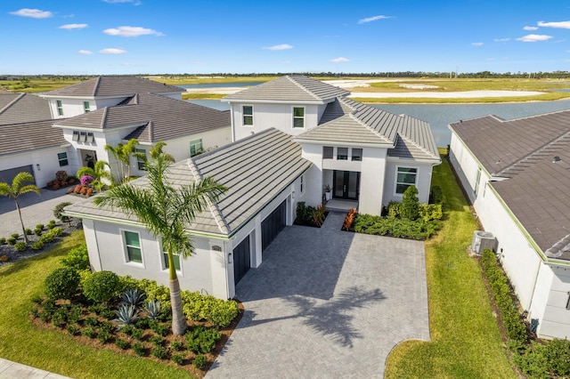 view of front facade featuring a water view and a garage