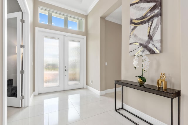 tiled entryway featuring crown molding and french doors