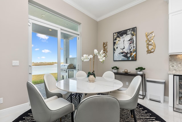 dining space featuring a water view and crown molding