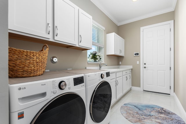 clothes washing area featuring sink, cabinets, washing machine and dryer, crown molding, and light tile patterned floors