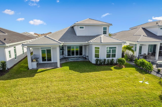 rear view of property with a lawn