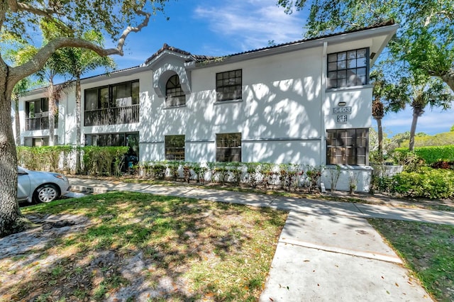 view of front of house with a tile roof and stucco siding