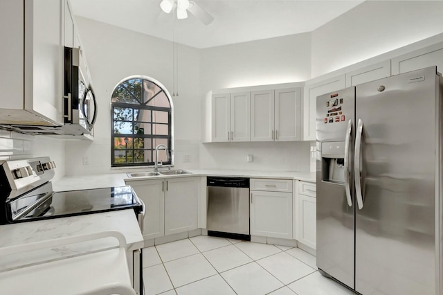 kitchen with light tile patterned flooring, a sink, ceiling fan, stainless steel appliances, and tasteful backsplash