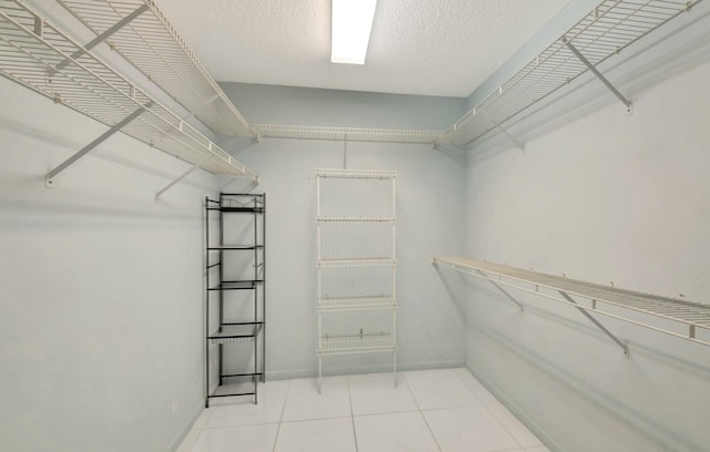 spacious closet featuring tile patterned floors