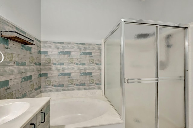 full bathroom with vanity, a shower stall, and a garden tub