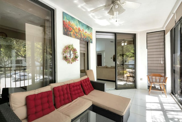 tiled living room with a wall of windows and a ceiling fan