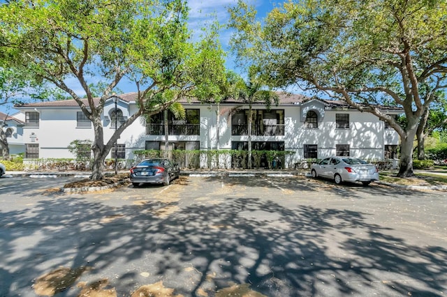 view of front of property featuring stucco siding and uncovered parking