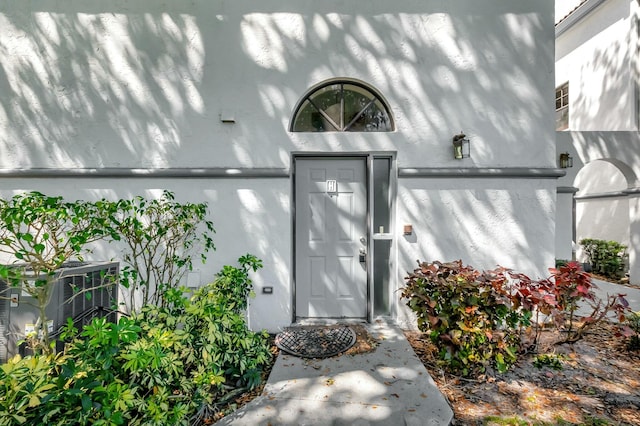 entrance to property featuring cooling unit