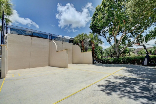 view of patio / terrace featuring community basketball court and fence