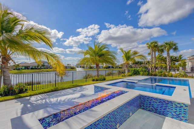 view of pool with an in ground hot tub and a water view