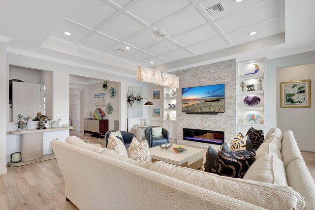 living room featuring built in shelves, a stone fireplace, light hardwood / wood-style floors, and coffered ceiling