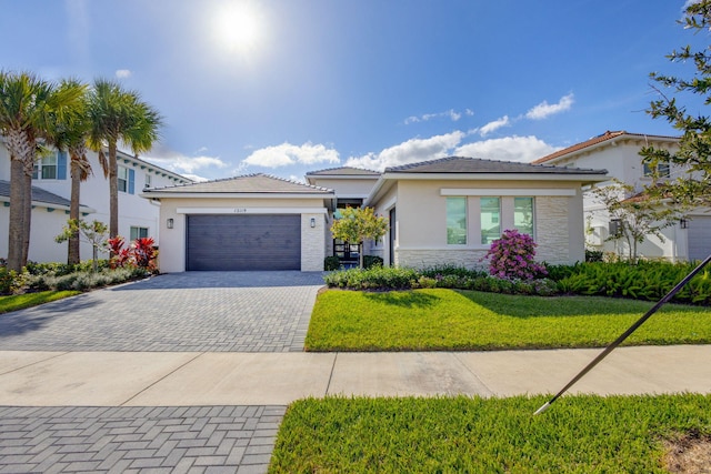 view of front of home with a garage and a front lawn