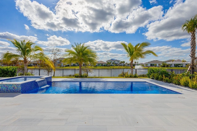 view of pool with a patio area, an in ground hot tub, a water view, and pool water feature