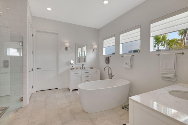 bathroom with vanity, tile patterned floors, plenty of natural light, and independent shower and bath