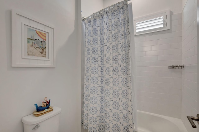 bathroom with shower / bath combination with curtain and toilet