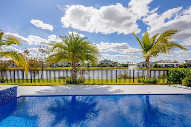 view of pool with a water view