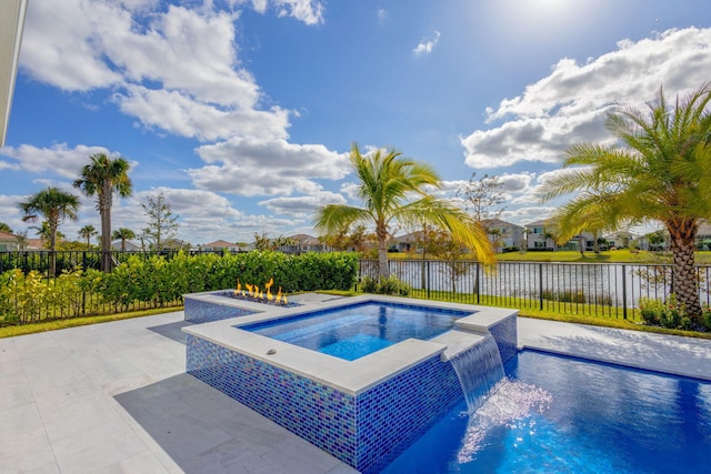 view of swimming pool featuring an in ground hot tub, pool water feature, and a water view