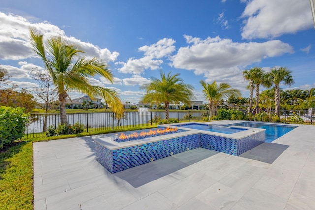 view of pool with an in ground hot tub, a water view, and an outdoor fire pit