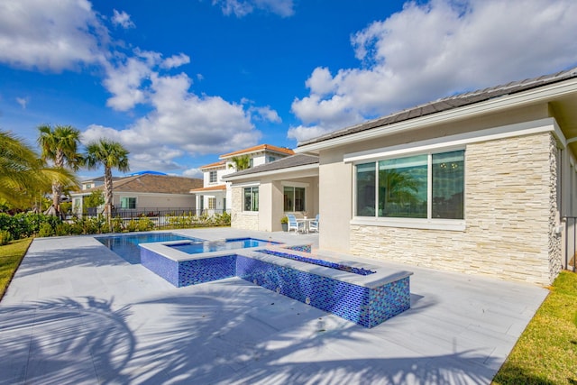 view of pool featuring an in ground hot tub and a patio