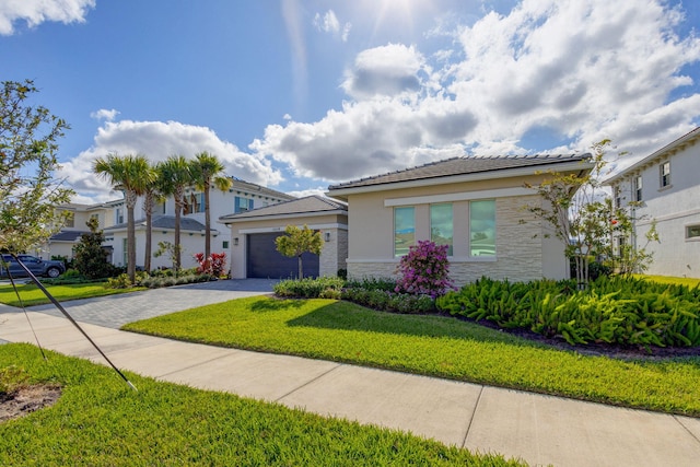 view of front of home featuring a garage and a front yard