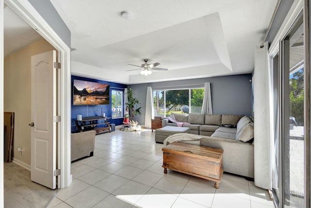 living room featuring light tile patterned floors and ceiling fan