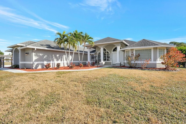 ranch-style house with covered porch and a front yard