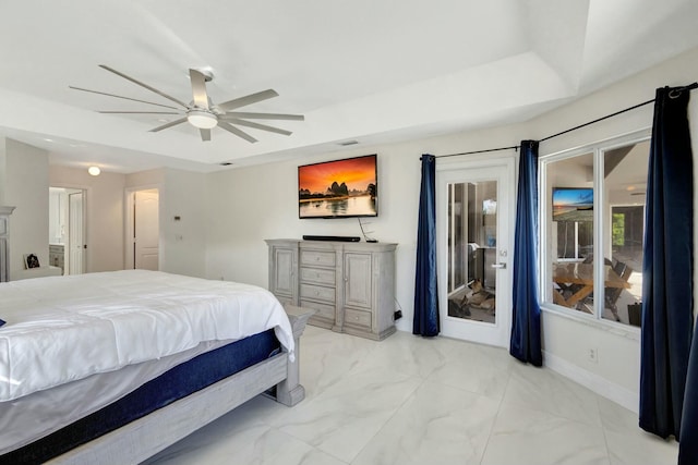 bedroom featuring a tray ceiling and ceiling fan