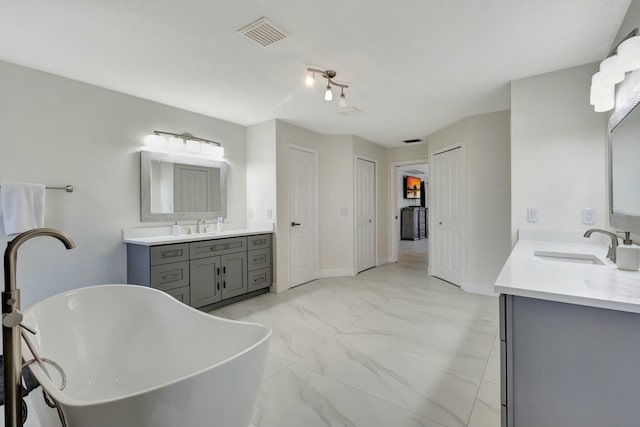 bathroom with a bath and vanity