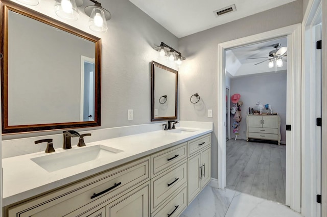 bathroom with hardwood / wood-style floors, vanity, and ceiling fan