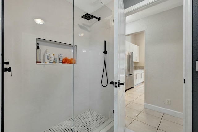 bathroom featuring tile patterned floors and a shower with shower door