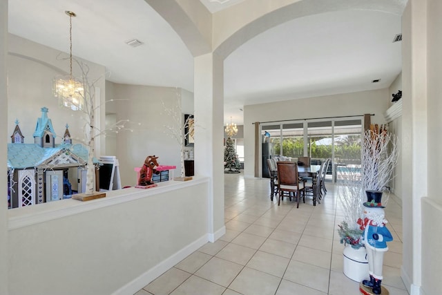 interior space with a chandelier and tile patterned flooring