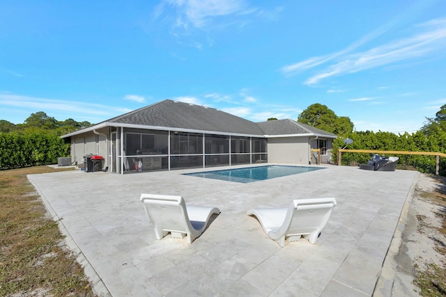 view of pool featuring a sunroom, central AC unit, and a patio