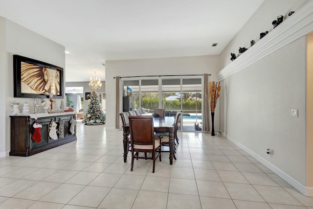 tiled dining space featuring a chandelier