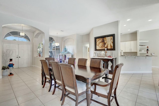 dining space featuring light tile patterned floors and an inviting chandelier