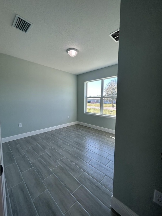 spare room with a textured ceiling