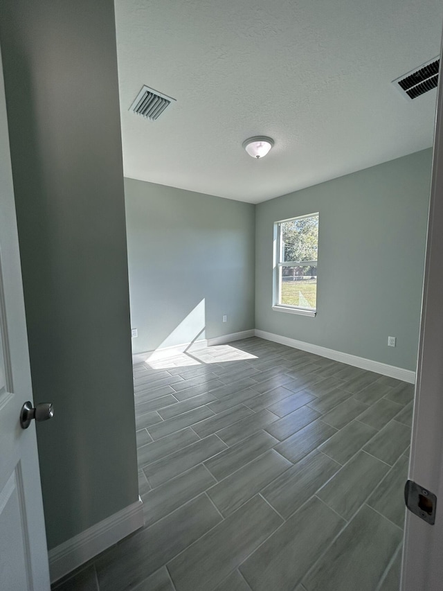 spare room featuring a textured ceiling