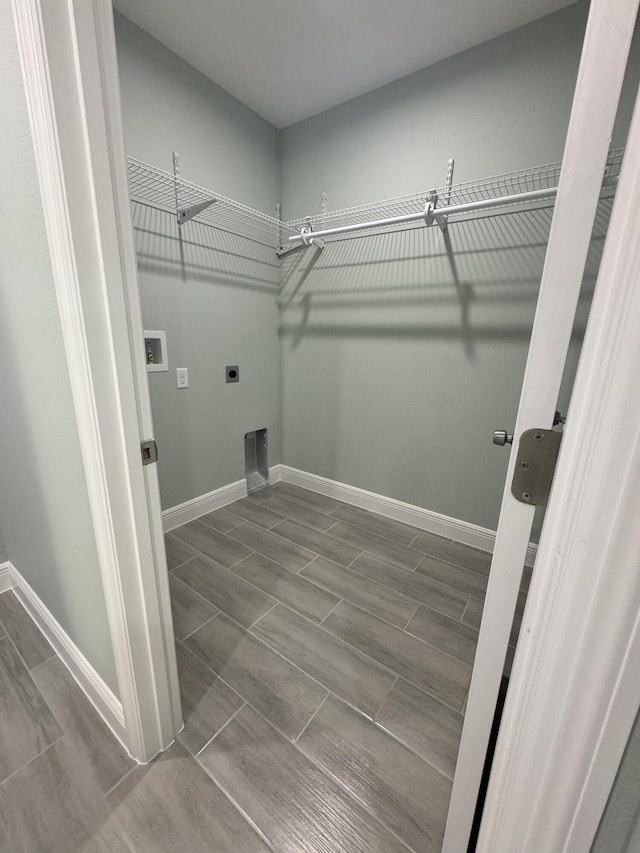 laundry room featuring electric dryer hookup, washer hookup, and hardwood / wood-style flooring