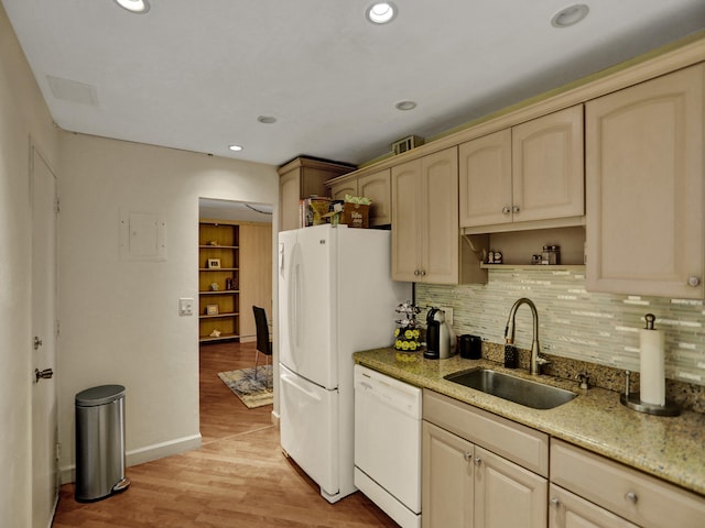 kitchen with sink, light brown cabinets, tasteful backsplash, white dishwasher, and light hardwood / wood-style floors