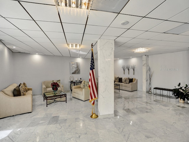 living room featuring a paneled ceiling