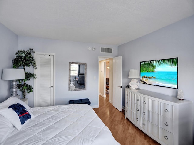 bedroom with a closet and light wood-type flooring