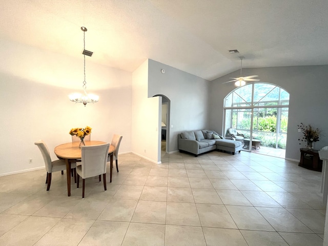 dining area featuring lofted ceiling and ceiling fan with notable chandelier