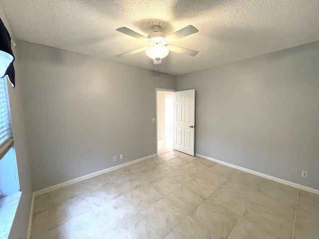 empty room with a textured ceiling and ceiling fan