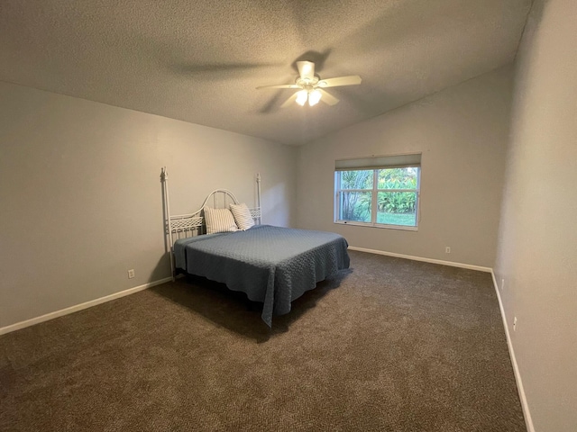 bedroom featuring lofted ceiling, ceiling fan, a textured ceiling, and dark colored carpet